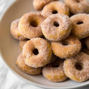 cinnamon sugar pumpkin donuts served on plate.