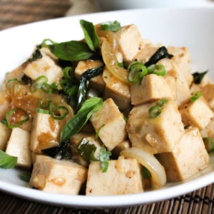 spicy basil tofu in a white serving dish.