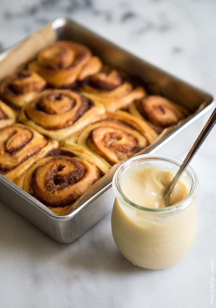 unfrosted coconut cinnamon rolls and a jar of coconut jam. 