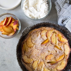 Whiskey Peach Clafoutis baked in cast iron skillet.