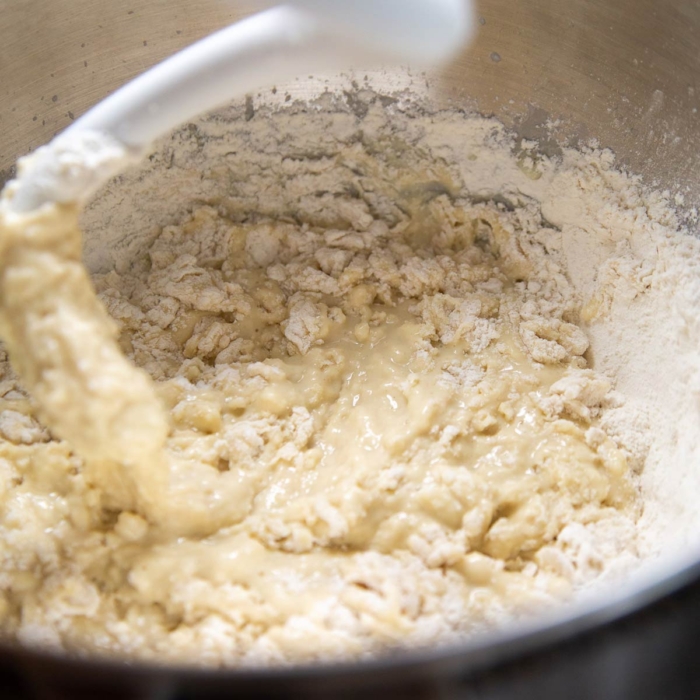 use dough hook attachment to mix together wet and dry ingredients.