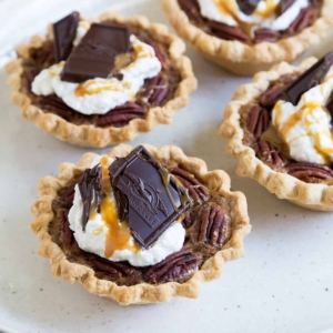 Mini Bourbon Caramel Derby Pies on serving platter.