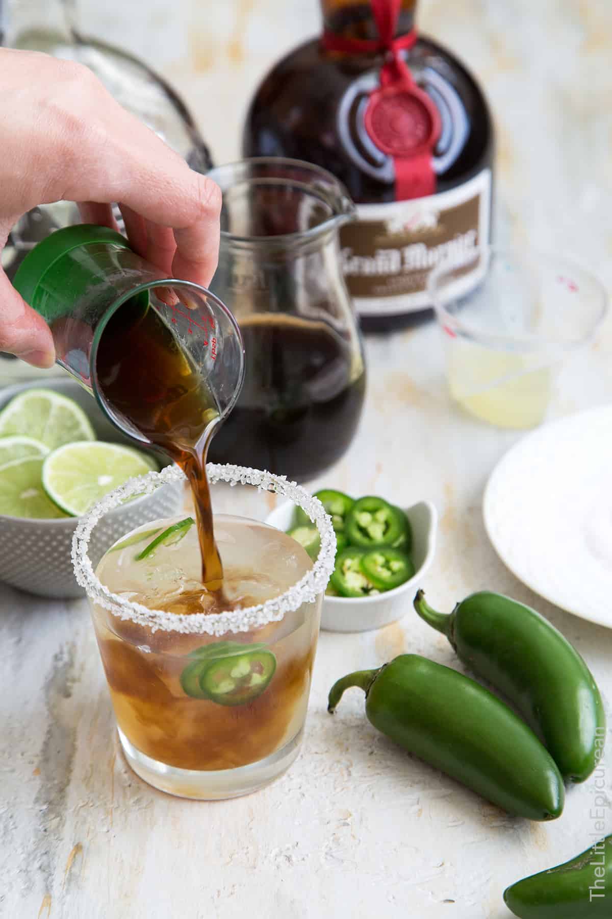 pour brown sugar jalapeno syrup into margarita drink. 