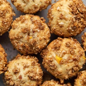 Almond Streusel Peach Muffins. Vanilla muffins mixed with fresh peaches and topped with almond streusel crumble.