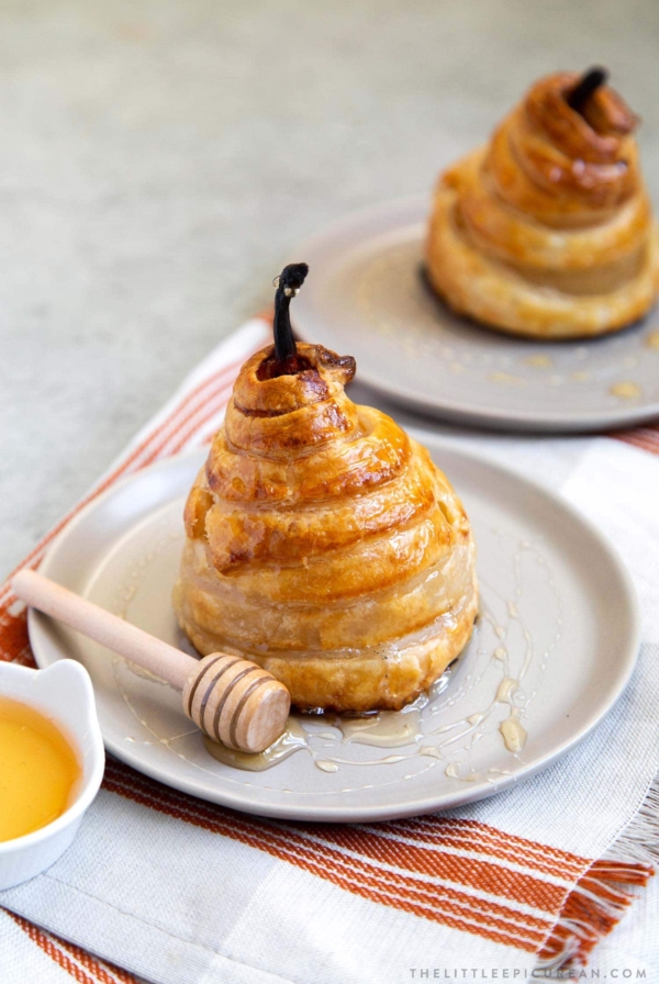 Poached Pear Puff Pastry. Pears poached in sweet vanilla cinnamon liquid. Encased in puff pastry and baked until golden. #pear #peardessert #falldessert #puffpastry