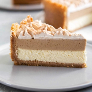 Coffee Mousse Cheesecake. Graham cracker crust, silky cheesecake layer topped with coffee mousse and whipped cream.