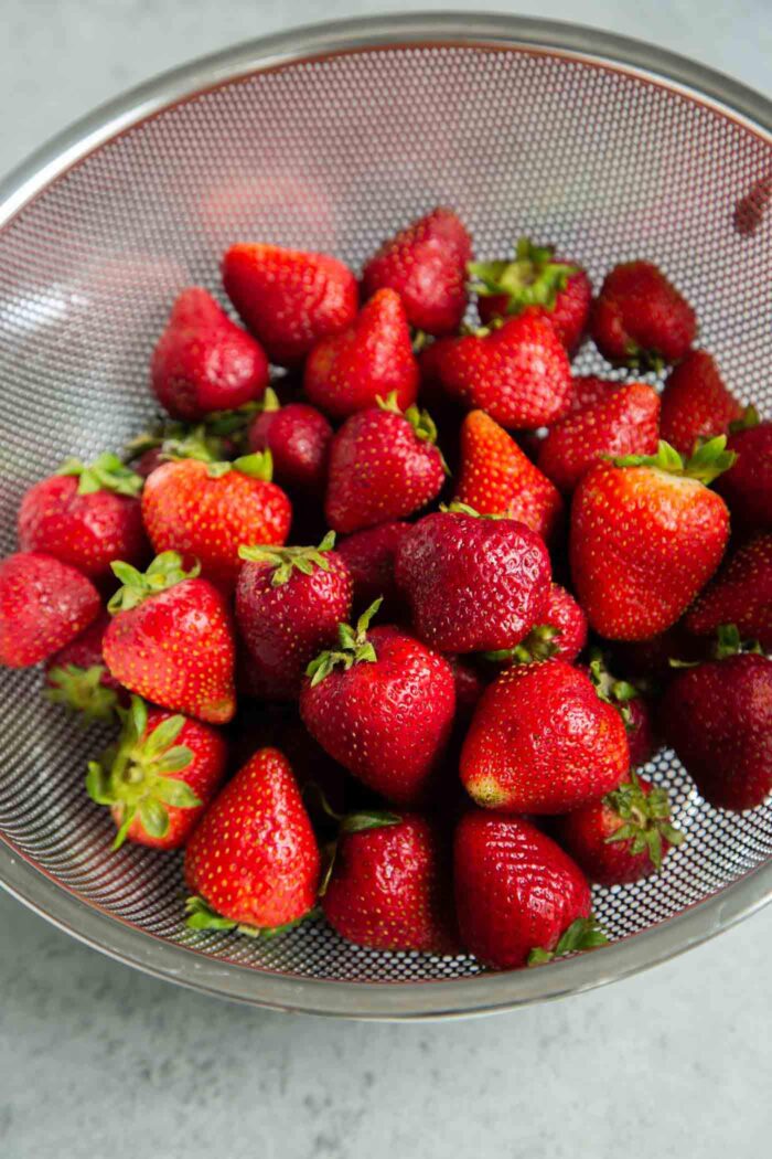 Clean strawberries before freezing