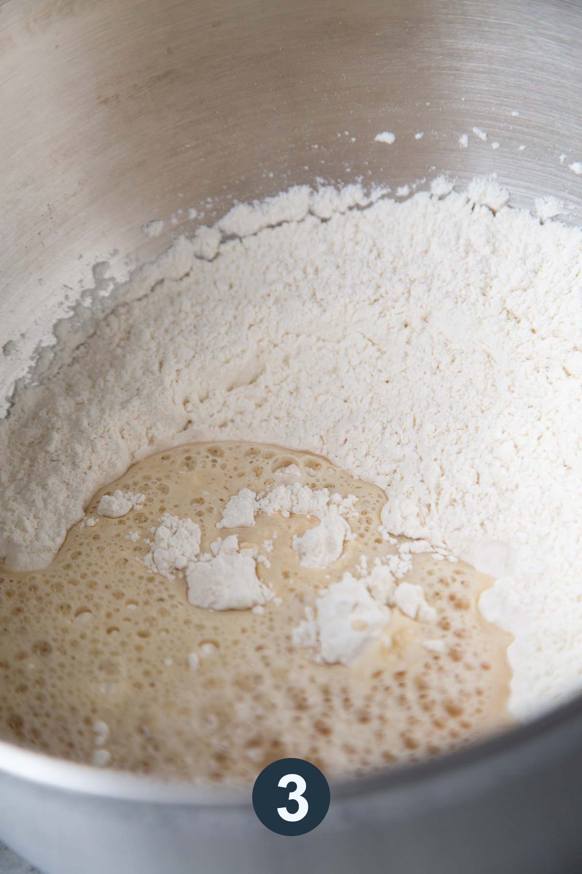 mix bread flour and yeast in a stand mixer with dough hook attachment.
