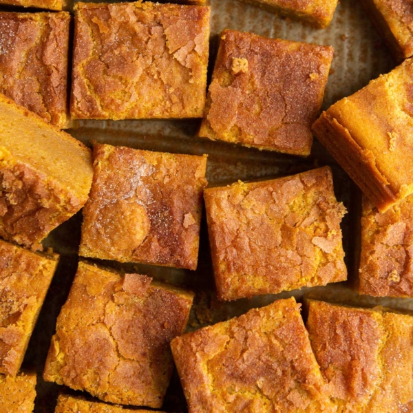 sliced portions of pumpkin butter mochi topped with cinnamon sugar.